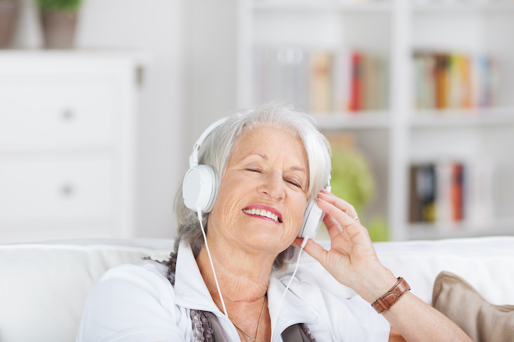 Why We Are So Attached to the Music of Our Youth, senior woman listening to music