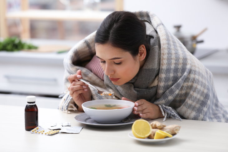 What to Eat & Avoid When You’re Sick ill woman eating soup
