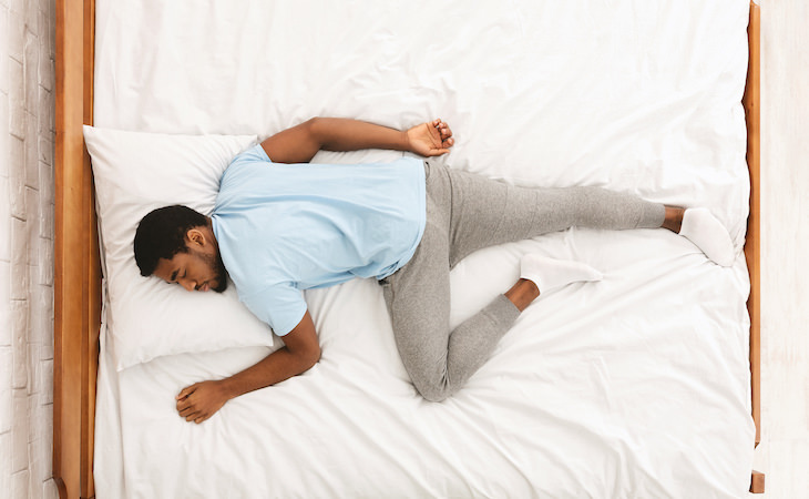 Stomach Sleeping: Worst Position For Your Health, man sleeping on his stomach