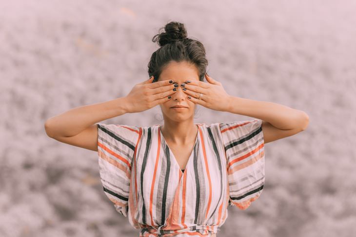 Eye Yoga woman covering her eyes with her hands