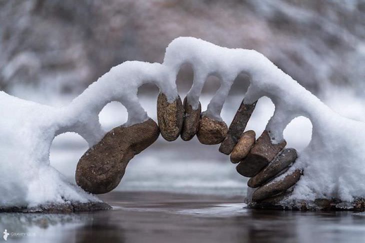 Stunning Accidental Snow Sculptures, Snow resting on a handmade stone arch