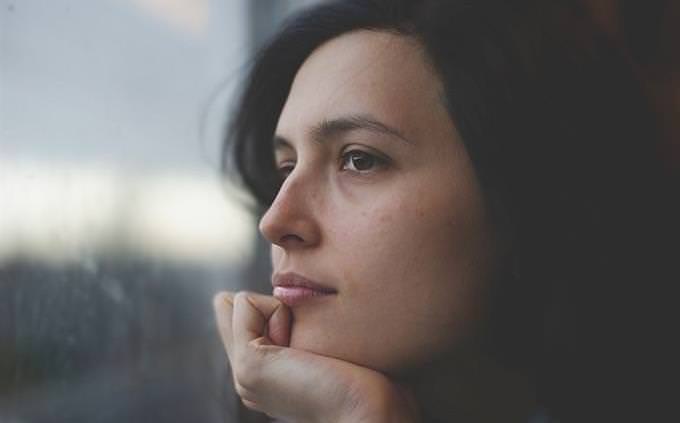 woman looking through the window