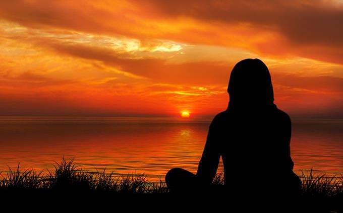 a woman at dusk meditating
