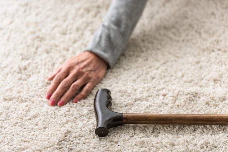 seniors health mistakes woman fell down on carpet