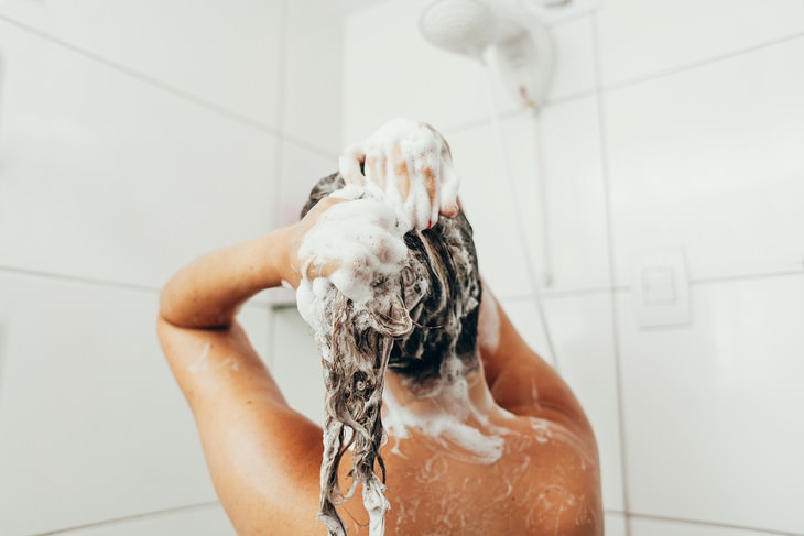 Tips to Help You Get Rid of Greasy Hair woman washing her hair