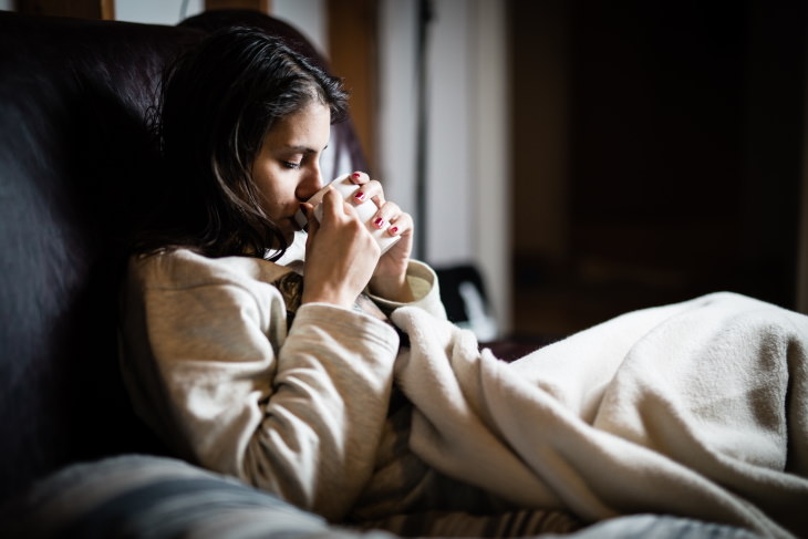 Peppermint Health Benefits woman drinking tea with a headache