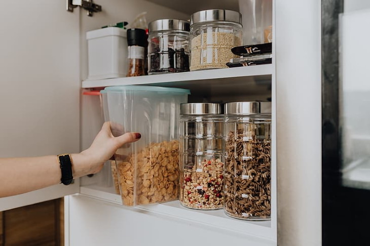 Spring Cleaning Health Benefits pulling out cornflakes out of the pantry