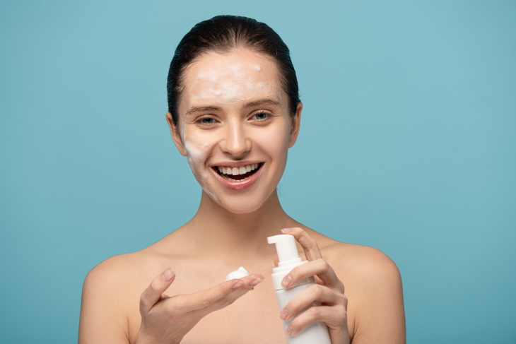 skincare tips coronavirus woman washing her face with a foam cleanser