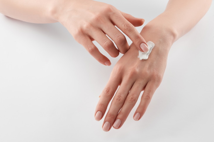 skincare tips coronavirus woman applying hand cream