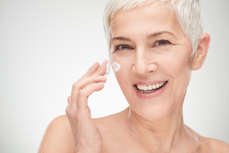 skincare tips coronavirus woman applying moisturizer on her face