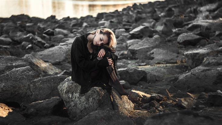 sad woman sitting on a beach