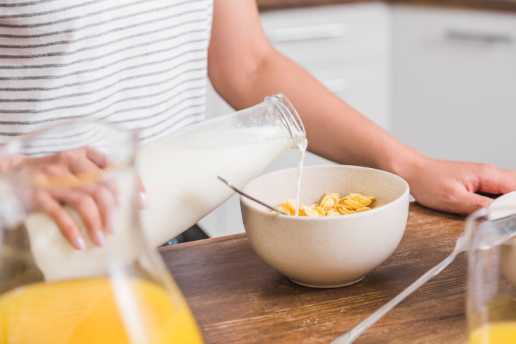 milk and breast cancer woman pouring milk into a bowl with cereal