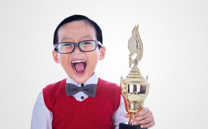 asian kid excited with a trophy