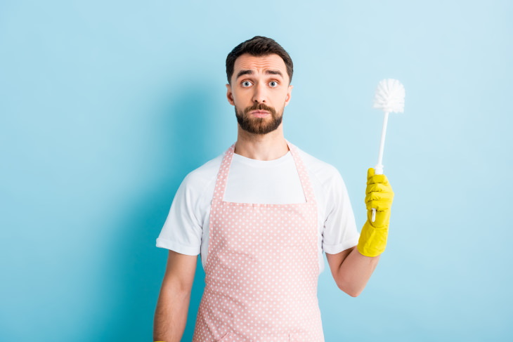 bathroom cleaning mistakes man with a toilet brush