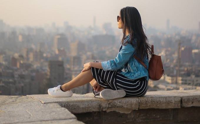 woman looking to the distance on a balcony