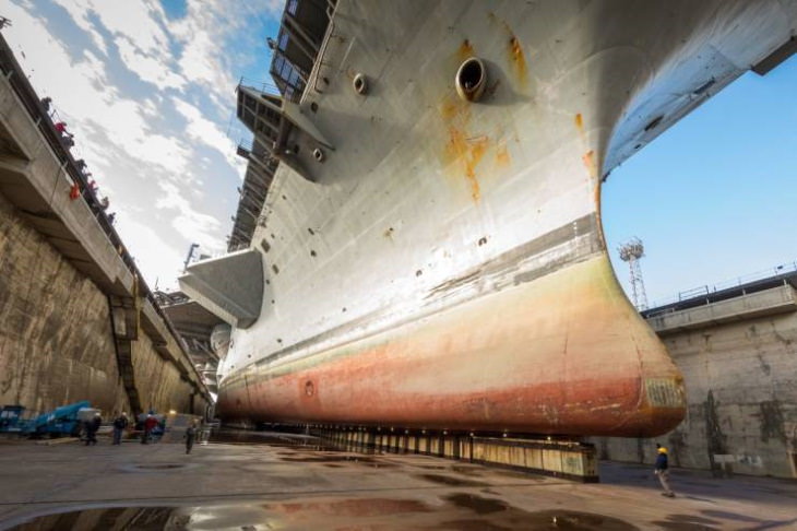 human scale photos Aircraft carrier in dry dock