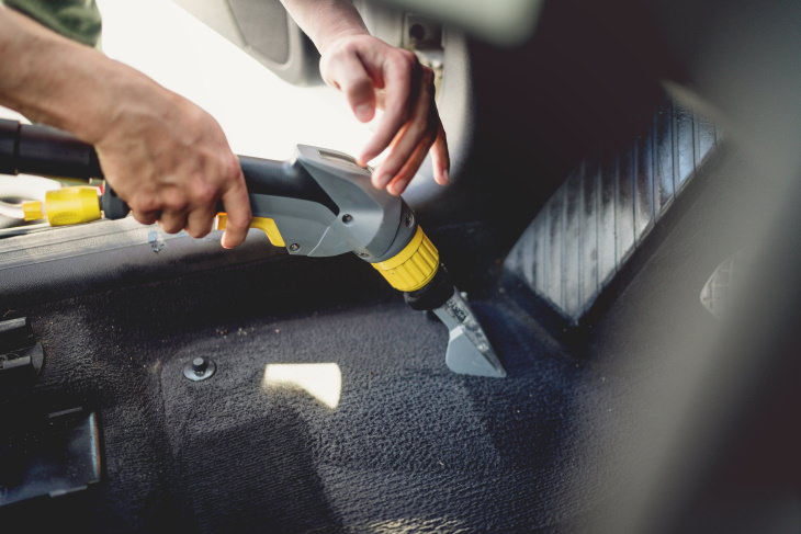 Cleaning the Car from Germs vacuuming car