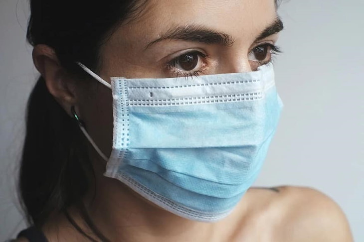 10 Tips to Help Skin Irritation and Acne When Wearing a Mask woman wearing a face mask