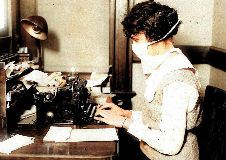 Photos From the Spanish Flu a typist at work in a mask in New York
