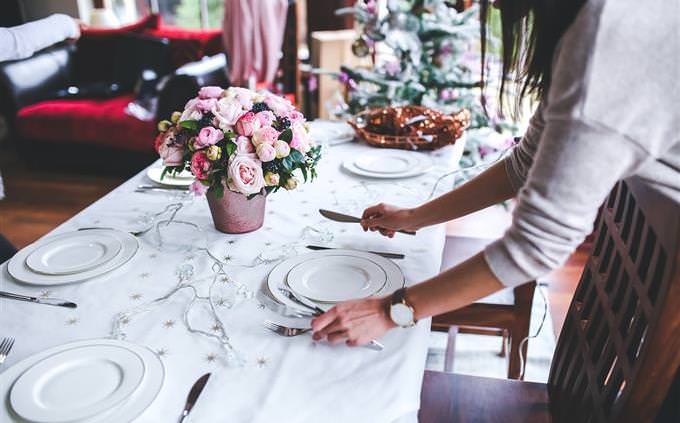 a woman setting a table