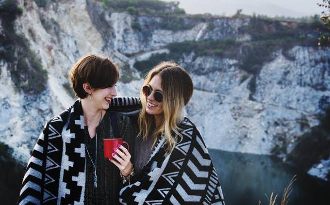 two women laughing at a natural setting