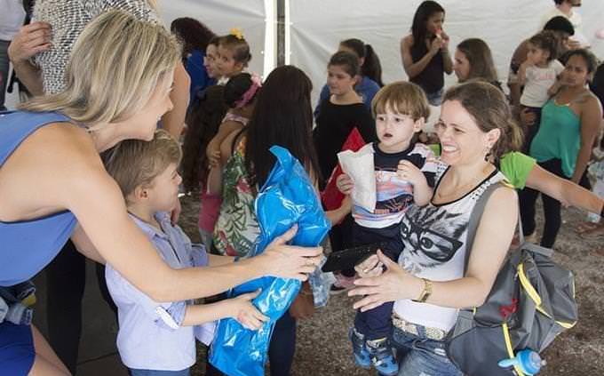 Woman giving package to people waiting in line