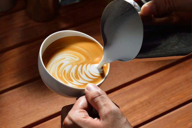 How To Upgrade Homemade Coffee to Coffeeshop Level pouring milk in latte