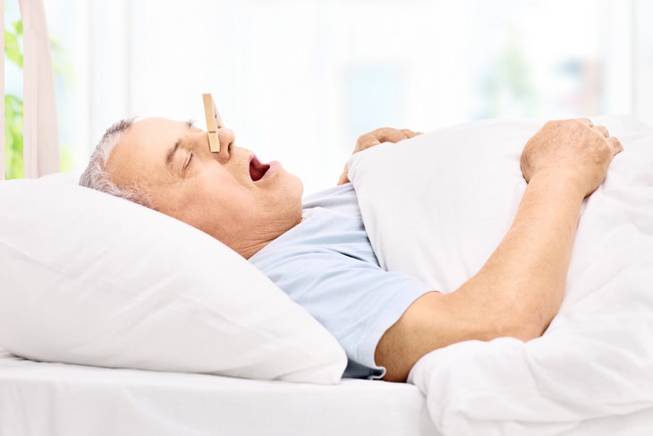 Take Control Of Your Wellbeing Through Breathing man sleeping with plugged nose