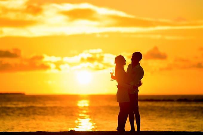 couple hugging on the beach at sunset