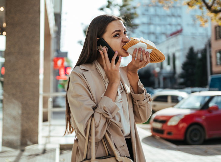 How to Eat Healthy When You’re Stressed woman eating toast on her way to work