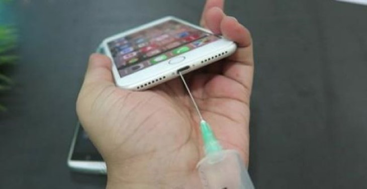 Smartphone Tips and Features cleaning a phone's charging port with a syringe
