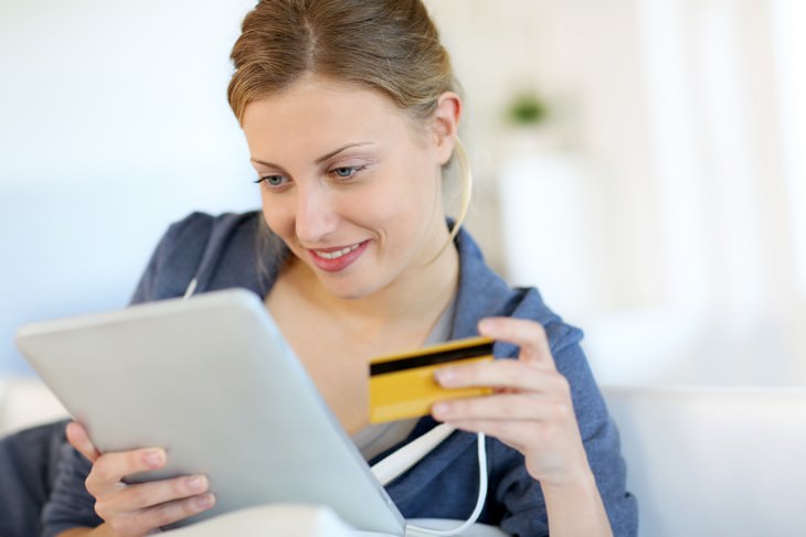 All the Risks and Benefits of ‘Buy Now Pay Later’ woman browsing online shop