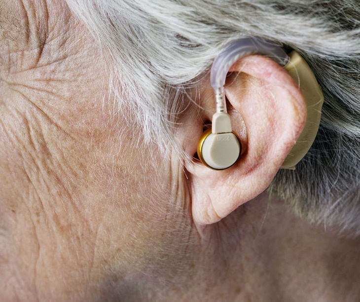 Hearing Loss Commorbidities person with a hearing aid