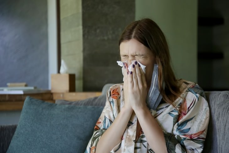 What Is Known About Asymptomatic Covid-19 woman sneezing