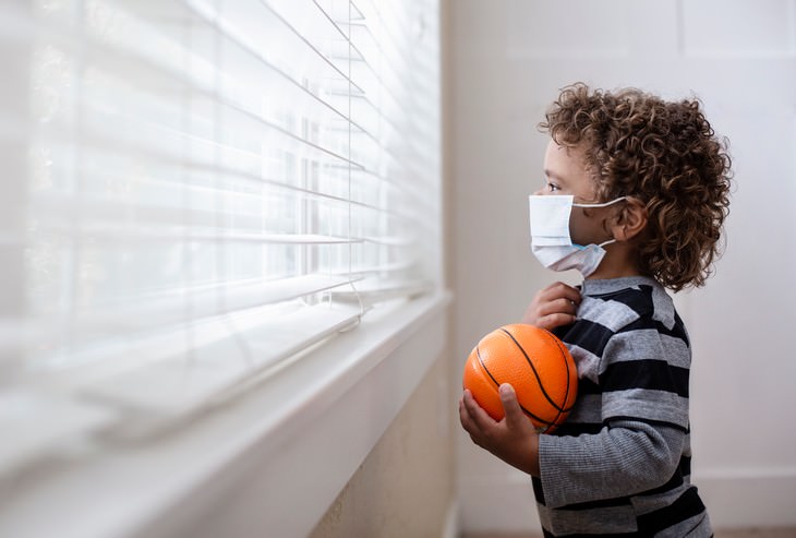 How Covid-19 Might Affect This Year’s Flu Season little bot looks out the window with face mask