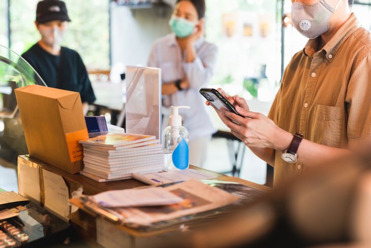 How Covid-19 Might Affect This Year’s Flu Season coffeeshop workers with masks