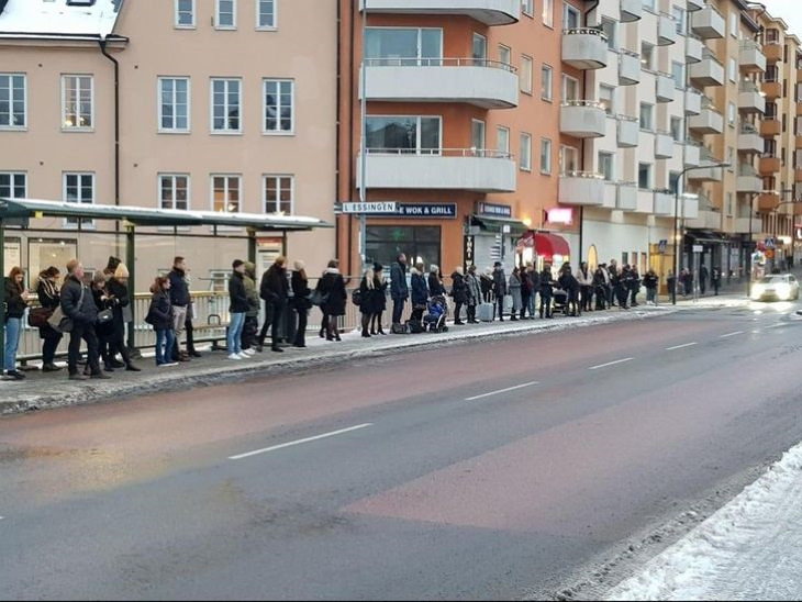 Sweden Photos stand in line while waiting for public transportation