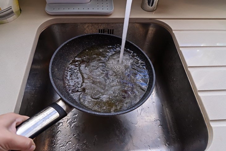 Plumbing Mistakes to Avoid greasy pan in sink