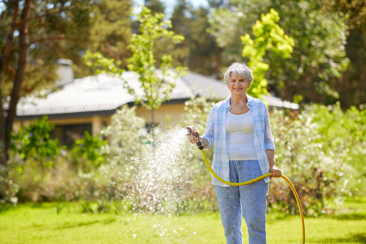 Gardening myths debunked, senior woman watering garden