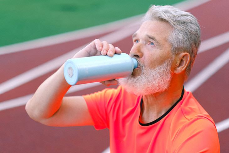 Walking Routine For Seniors man drinking water from flask