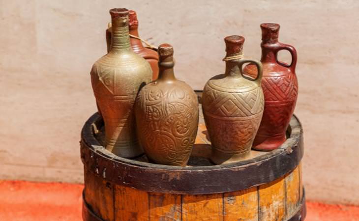 ancient wine bottles on a wood barrel 