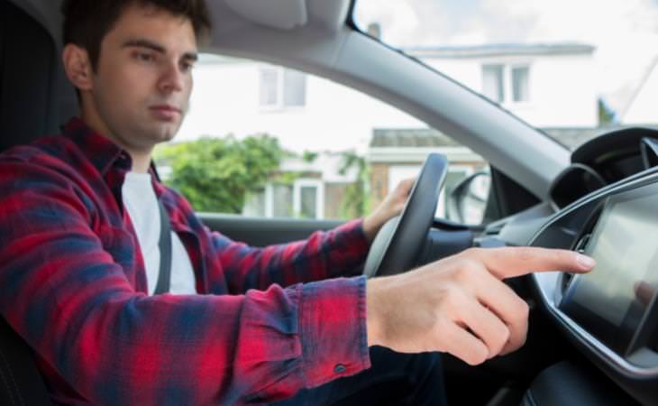 man in a car with touchscreen