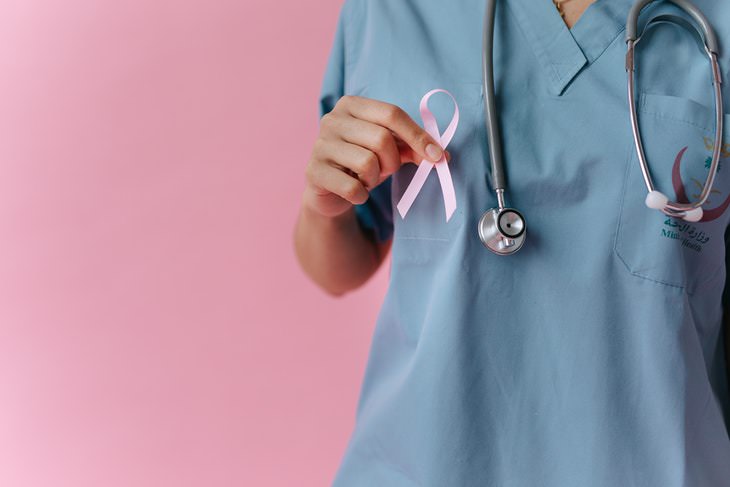 Breast Cancer Myths doctor holding pink breast cancer awareness ribbon