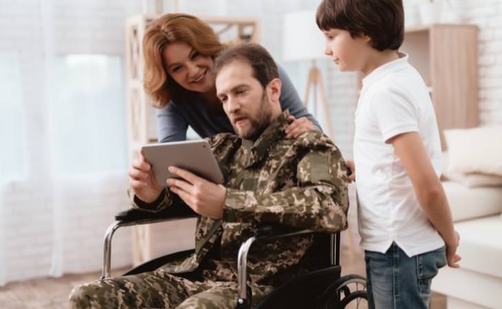 woman and boy with a veteran in a wheelchair 