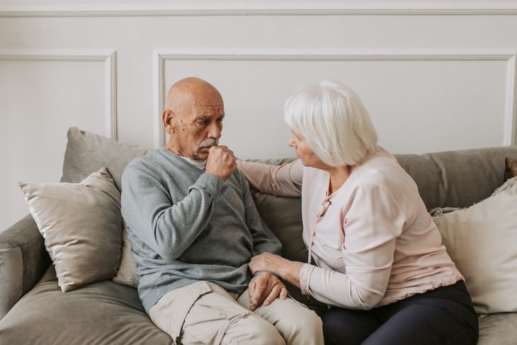 6 Types of Pneumonia older man coughing near concerned older woman