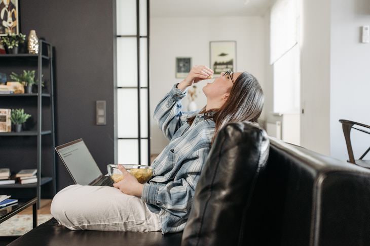 Breathing Exercises For Weight Loss woman eating chips on the couch