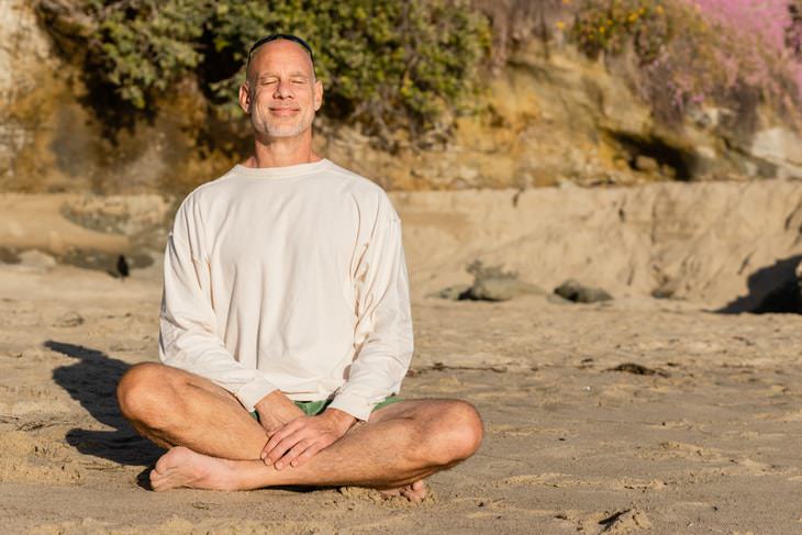 Breathing Exercises For Weight Loss smiling man meditating on the beach