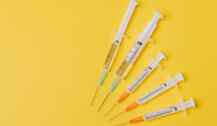 syringes over yellow background 