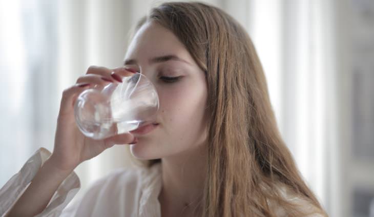woman drinking glass of water 