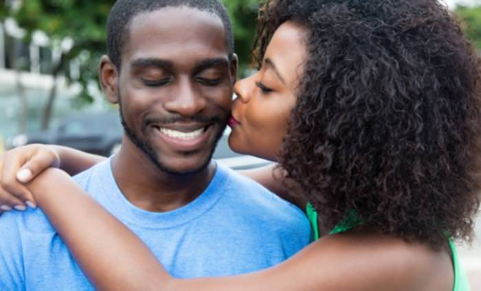 couple kissing on the cheek